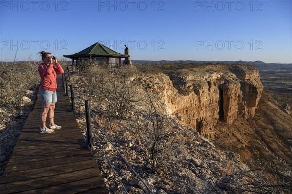 Tourist looking through binoculars