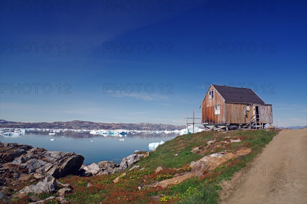 Simple cabin on a fjord