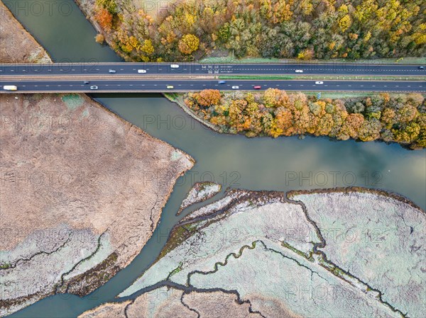 Top Down view over Marshland and Bridge of River Teign shrouded in frost at morning sun from a drone