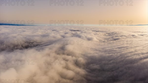 Aerial view over the sea of fog in the Central Plateau with Sahara dust in the air