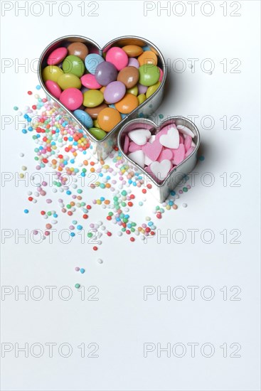 Chocolate lentils and love beads in heart-shaped cookie cutter