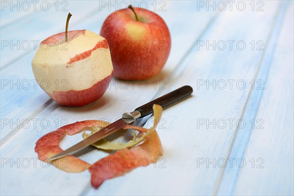 Peeled apple with peeling knife