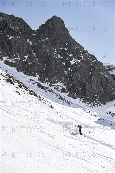 Ski tourers on the ascent in a saddle