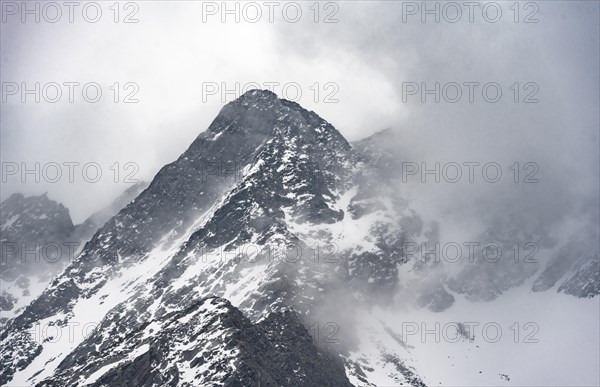 Mountains in winter with clouds and fog