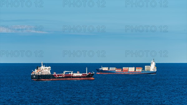 Oil Tanker and Container Ship at sea with Barcelona in the background