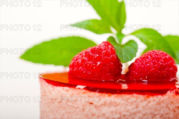 Fresh raspberry cake mousse dessert round shape with mint leaves