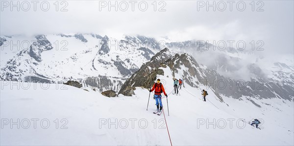 Ski tourers ascending the rope