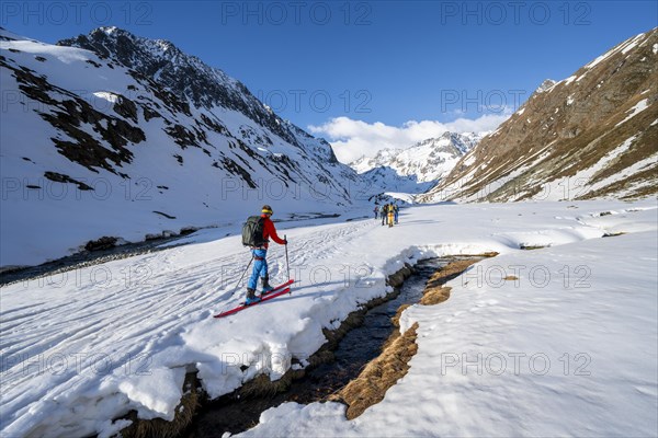 Ski tourers in a valley at Oberbergbach