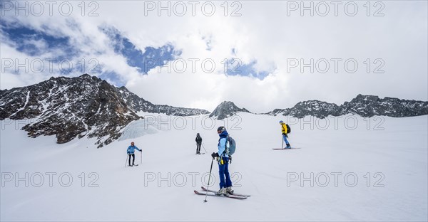 Group of ski tourers and splitboarders on the descent at Alpeiner Ferner