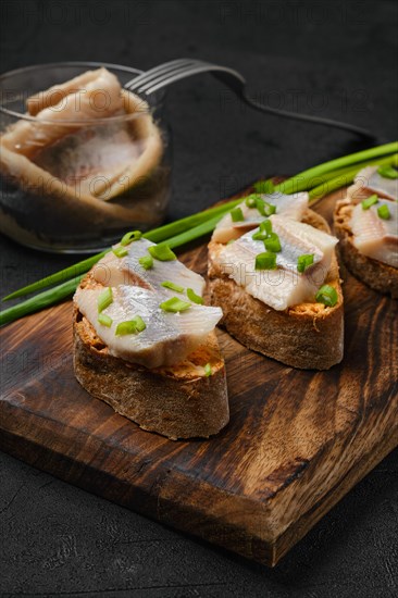 Sandwich with salty herring and spring onion