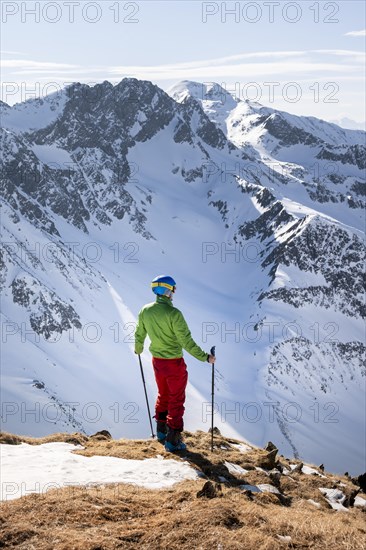 Hiker looking at Stubai Alps from Mitterzeigerkogel