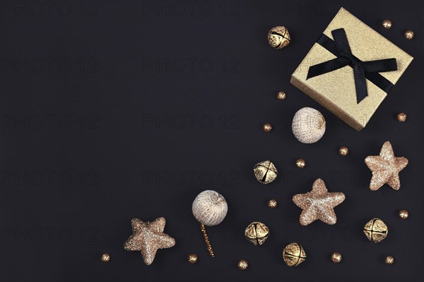 Christmas flat lay with golden gift box surrounded by shiny star