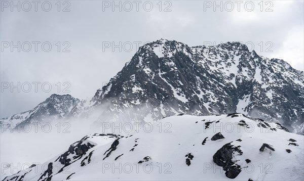 Mountains in winter with clouds and fog