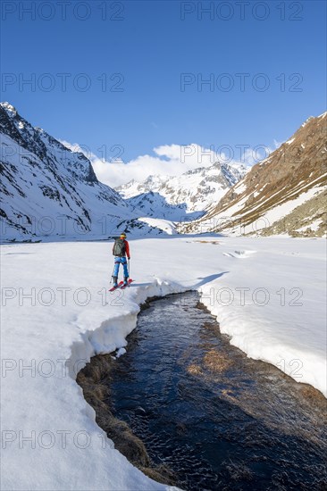 Ski tourers in the Oberbergtal valley on the Oberbergbach stream