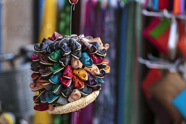 Different coloured Moroccan slippers for children at a stall in the old town