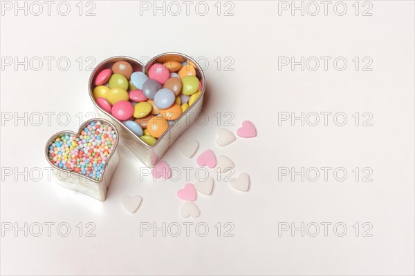 Chocolate lentils and love beads in heart-shaped cookie cutter