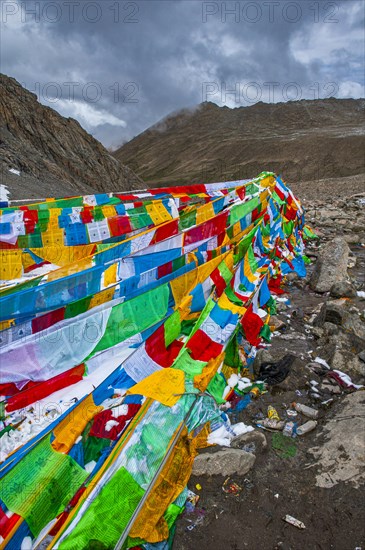 Praying flags and stones on a mountain pass