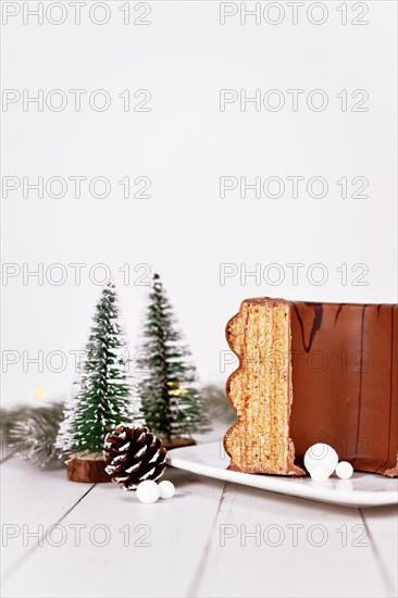Traditional German layered winter cake called 'Baumkuchen' glazed with chocolate
