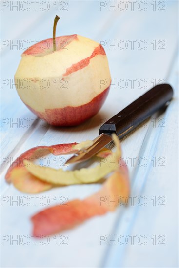 Peeled apple with peeling knife