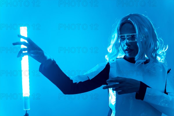 A woman in a futuristic suit and glasses with blue lights