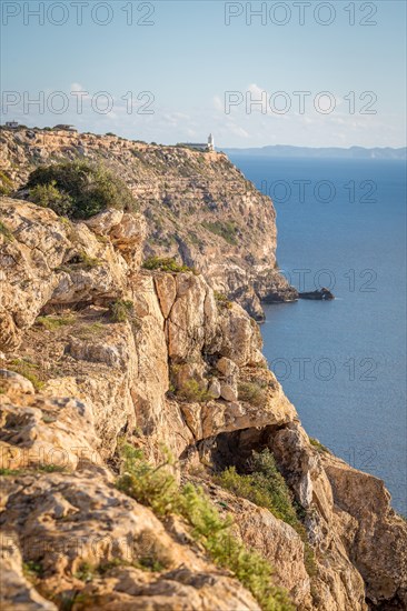 View of cliff with lighthouse Far de Cap Blanc in the south of Majorca