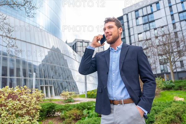 Businessman or finance man talking on the phone outside the office