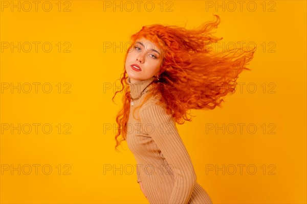 Red-haired woman on a yellow background