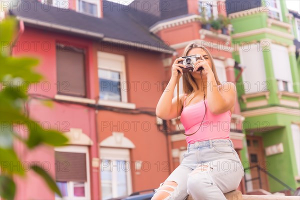 Blonde tourist in a street with houses with colorful facades