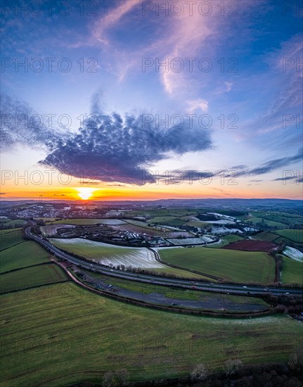 Sunset over Fields and Farms shrouded in frost from a drone