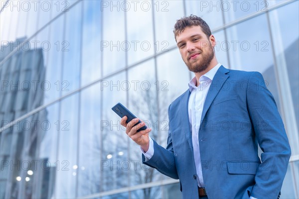 Portrait of corporate male entrepreneur outside the office in a glass building