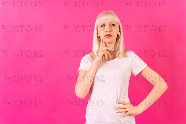 Blonde caucasian girl studio shot on pink background