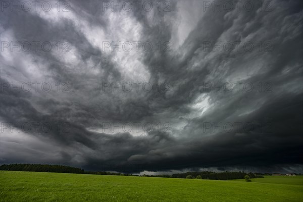 Road and meadows with thunderstorm sky in the background