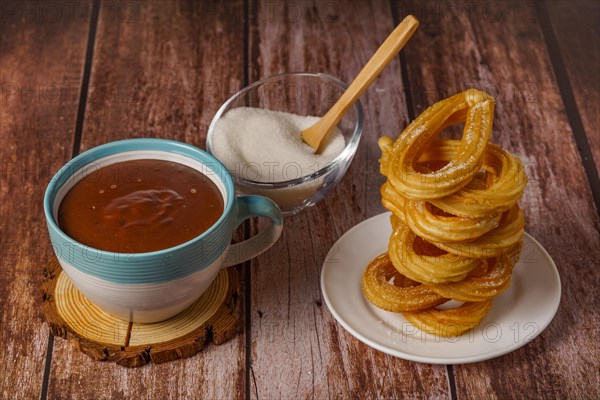 Hot chocolate with churros in a white and blue cup