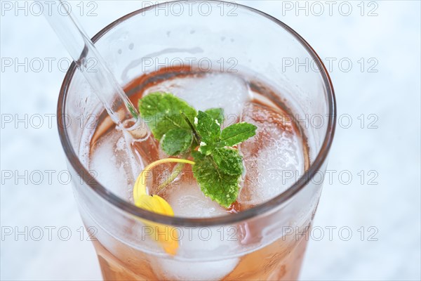 Glass with quince juice and a glass straw