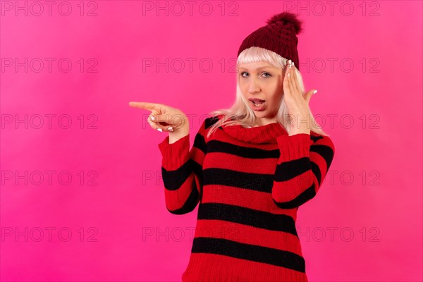 Blonde caucasian girl on pink background studio