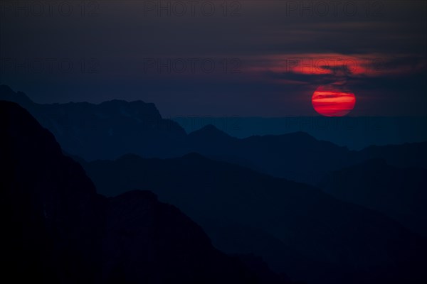 Fiery sunball at sunset with Lechtaler Alps