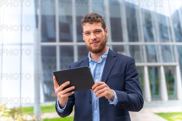 Portrait of a young male businessman or entrepreneur outside the office