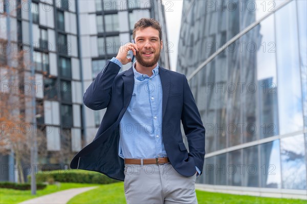 Businessman or finance man talking on the phone outside office