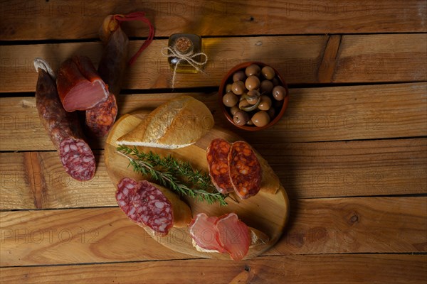 Top view of a wooden board with sausage. chorizo