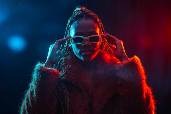 Black ethnic woman with braids with blue and red led lights