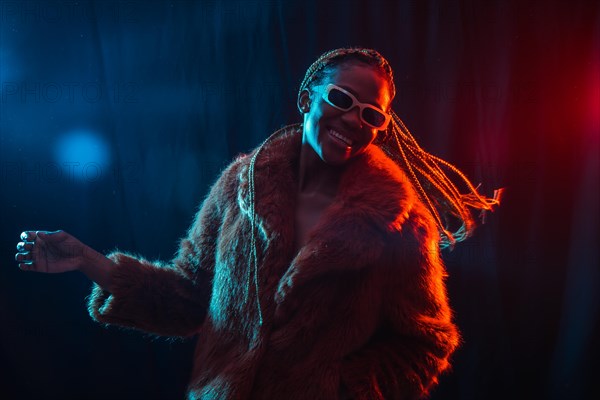 Black ethnic woman with braids with blue and red led lights