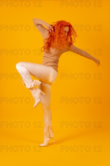 Red-haired woman on a yellow background