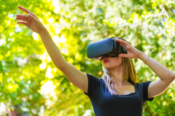 Woman with virtual reality glasses enjoying nature