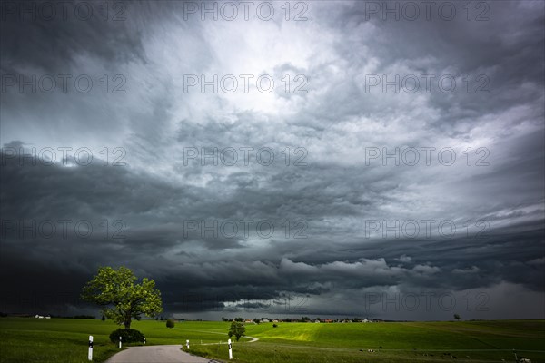 Road and meadows with thunderstorm sky in the background