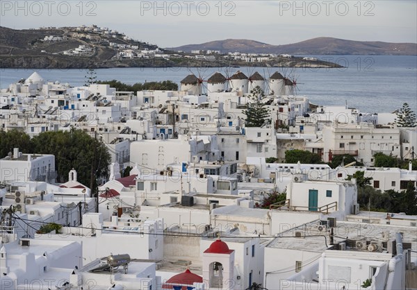 View over the white Cycladic houses of Mykonos town with windmills