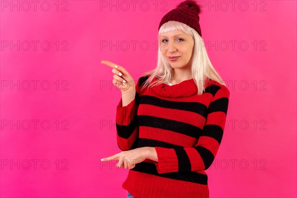 Blonde caucasian girl on pink background studio