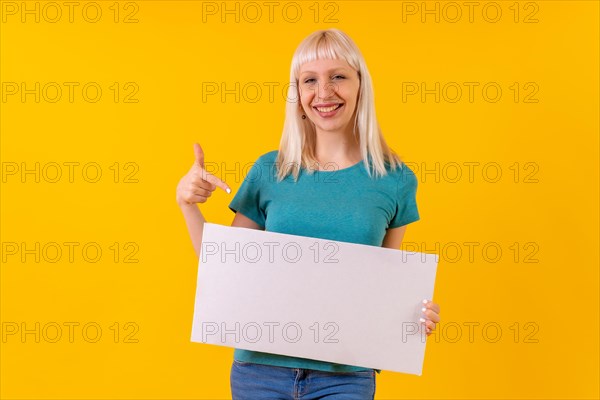 Pointing at white empty advertisement poster