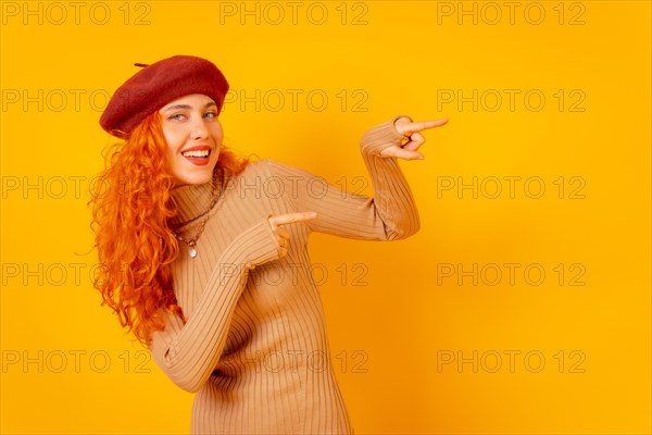 Red-haired woman in a red beret on a yellow background