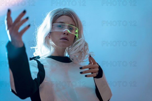 Woman watching with the illuminated futuristic glasses