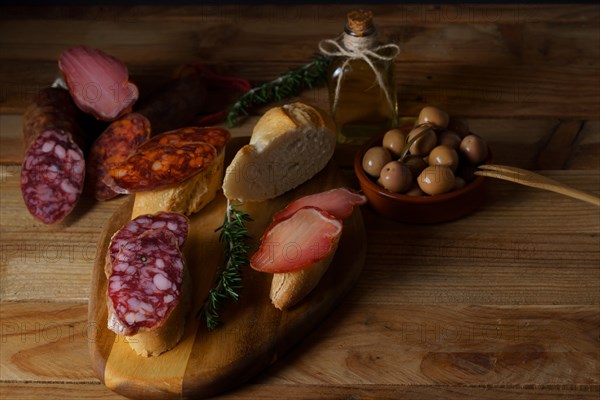 Top view of a wooden board with sausage. chorizo